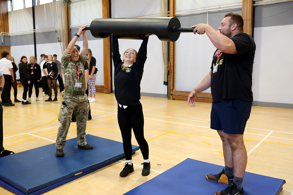 Students at Carterton Community College having a go at some weight lifting challenges.